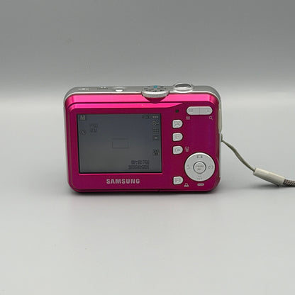 Rear view of a pink Samsung S860 showing the illuminated LCD screen and control buttons