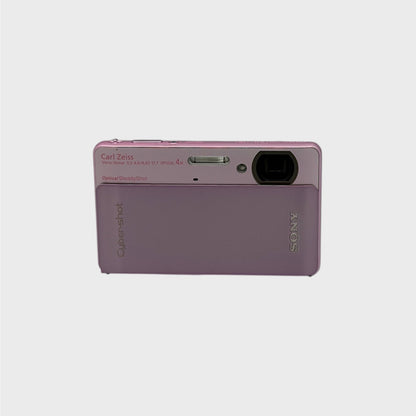 Front view of a pink Sony Cyber-shot DSC-TX5 showing the exposed lens and flash