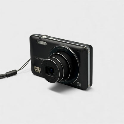 Black Olympus VG-120 viewed from the opposite front corner with its lens extended