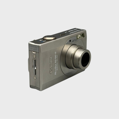 Angled front view of a silver Canon PowerShot SD790 IS showing the extended lens and top controls