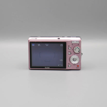 Pink Kodak EasyShare M1073 IS rear view showing the LCD screen and circular controls.