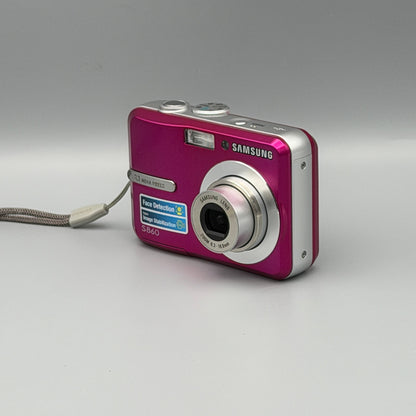 Front and side view of a pink Samsung S860 with its lens extended