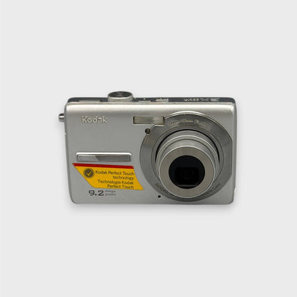 Front view of a silver Kodak EasyShare M320 with its lens extended