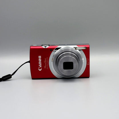 Front view of a red Canon PowerShot ELPH 140 IS with its silver lens extended