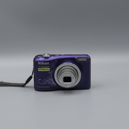 Purple Nikon Coolpix A10 front view with a decorative swirl pattern and extended silver lens.