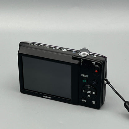 Nikon Coolpix S2800 viewed from a rear angle showing the LCD screen and control buttons.