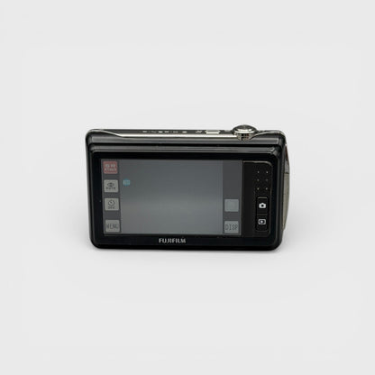 Rear view of a black Fujifilm FinePix Z90 showing its illuminated LCD touchscreen