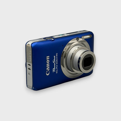 Blue Canon PowerShot ELPH 100 HS viewed from a front angle with its silver lens extended.