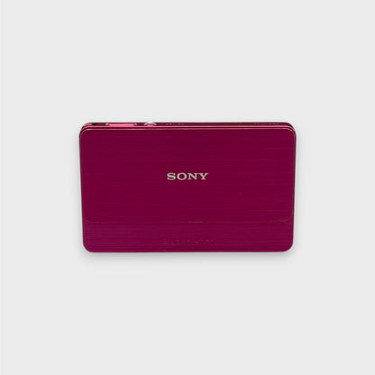 Front view of a pink Sony Cyber-shot DSC-T700 with its brushed sliding lens cover closed