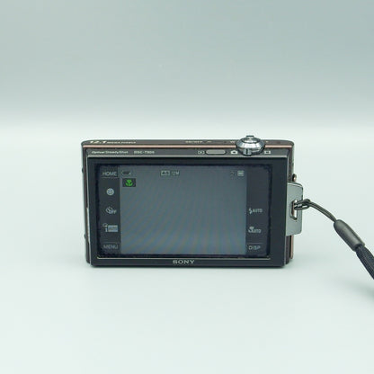 Rear view of a brown Sony Cyber-shot DSC-T900 with shooting controls visible on its wide LCD screen