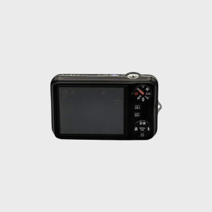 Rear view of a black Fujifilm FinePix JV100 showing its LCD screen, mode dial and control buttons