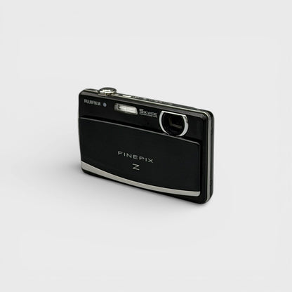 Front and side view of a black Fujifilm FinePix Z90 showing the exposed lens