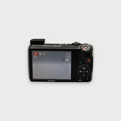 Fujifilm FinePix F300EXR rear view showing the LCD screen, control dial and raised flash.