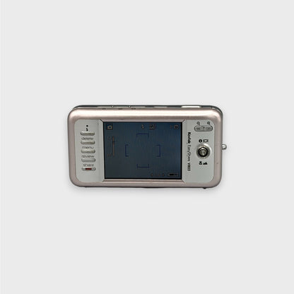 Rear view of a pink Kodak EasyShare V803 showing the illuminated LCD screen and control buttons