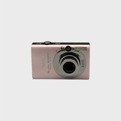 Pink Canon PowerShot SD1100 IS front view with its lens extended.