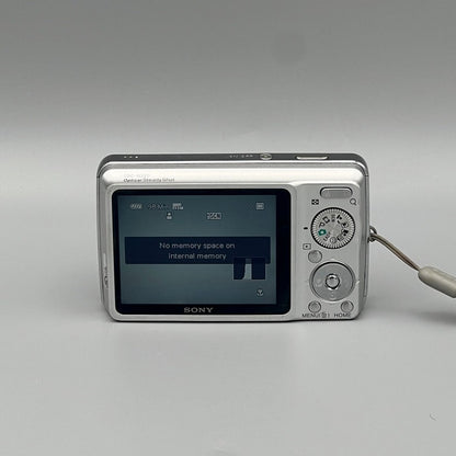Rear view of a silver Sony Cyber-shot DSC-W220 showing its LCD screen, mode dial and control buttons