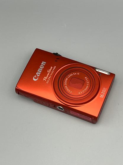 Angled front and underside view of a red Canon PowerShot ELPH 110 HS with its lens closed