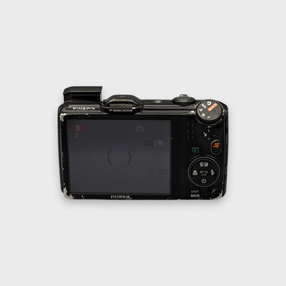Fujifilm FinePix F550EXR rear view showing the LCD screen, control dial and raised flash.
