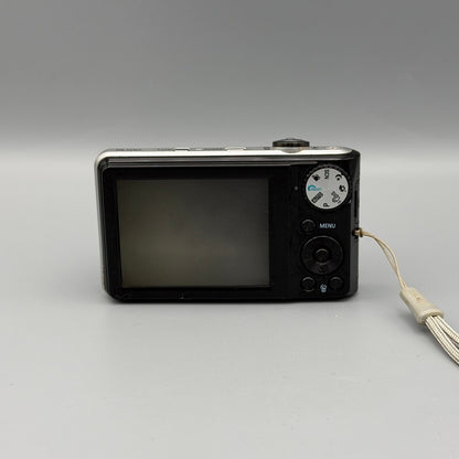 Rear view of a black Samsung PL100 showing its LCD screen, mode dial and circular control pad