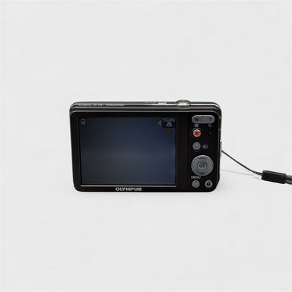 Rear view of a black Olympus VG-120 showing its LCD screen and silver control buttons