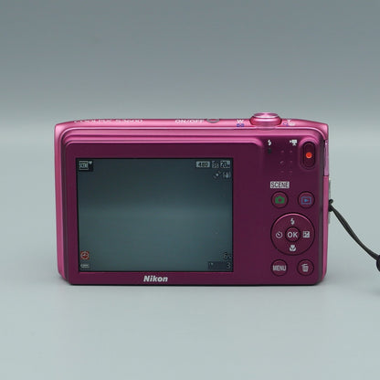 Rear view of a pink Nikon Coolpix S3600 showing its LCD screen and matching pink control buttons