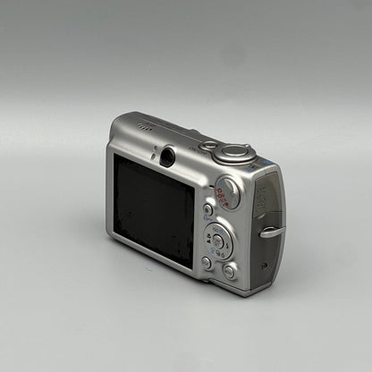 Canon PowerShot SD550 viewed from a rear angle showing the LCD screen, controls and side panel.