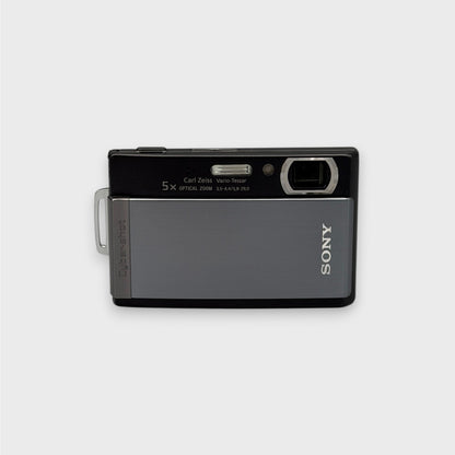 Front view of a gray and black Sony Cyber-shot DSC-T300 showing the exposed lens and flash