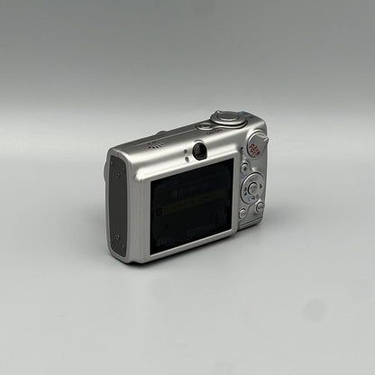 Canon PowerShot SD550 viewed from a rear angle showing the LCD screen, viewfinder and controls.