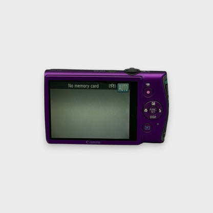 Rear view of a purple Canon PowerShot ELPH 310 HS showing the illuminated LCD screen and control buttons