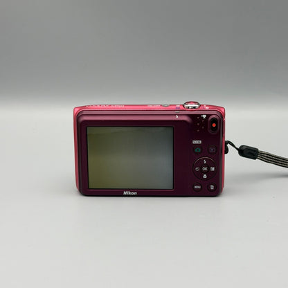 Rear view of a pink Nikon Coolpix S3500 showing the illuminated LCD screen and control buttons