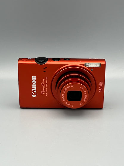 Front view of a red Canon PowerShot ELPH 110 HS with its lens extended