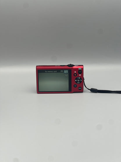 Rear view of a red Canon PowerShot ELPH 130 IS showing its LCD screen, control buttons and wrist strap