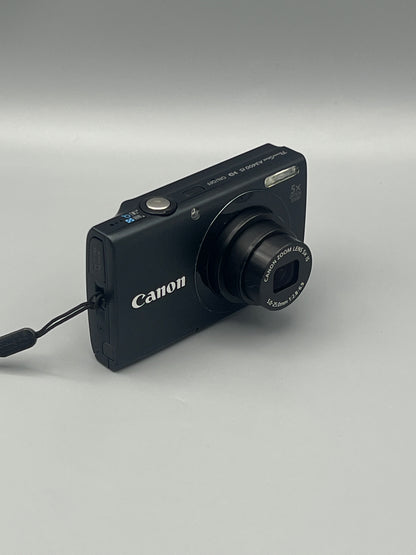 Angled front view of a black Canon PowerShot A3400 IS showing the extended lens and top controls