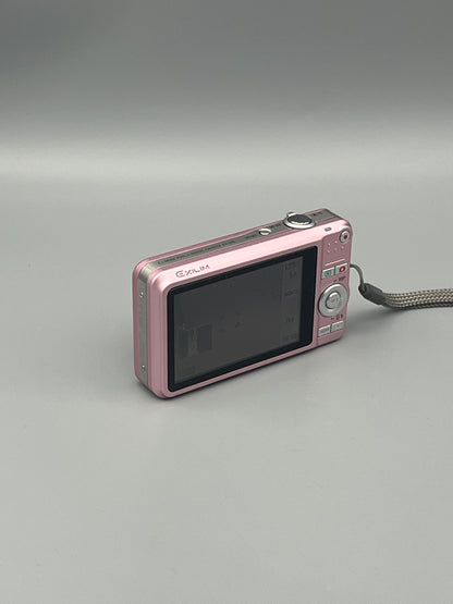 Pink Casio Exilim EX-Z85 viewed from a rear angle showing the LCD screen and control buttons.