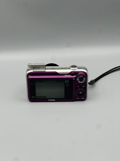 Rear view of a purple Canon PowerShot SX220 HS showing the LCD screen and control buttons