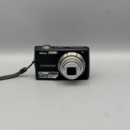 Front view of a black Nikon Coolpix S630 digital camera with its lens extended