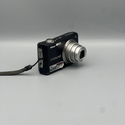 Angled front view of a black Nikon Coolpix S630 showing the extended lens and top controls