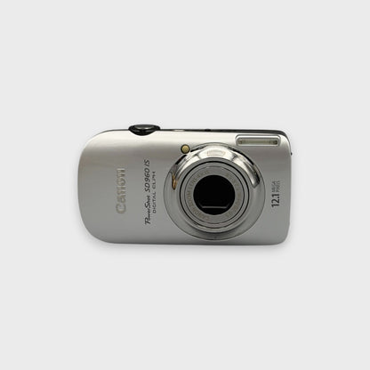 Silver Canon PowerShot SD960 IS front view with its lens extended.
