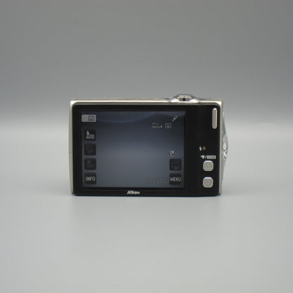 Rear view of a silver Nikon Coolpix S4000 with shooting controls visible on its LCD screen