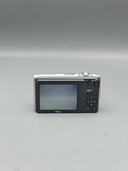 Rear view of a silver Nikon Coolpix S3600 showing its LCD screen and control buttons