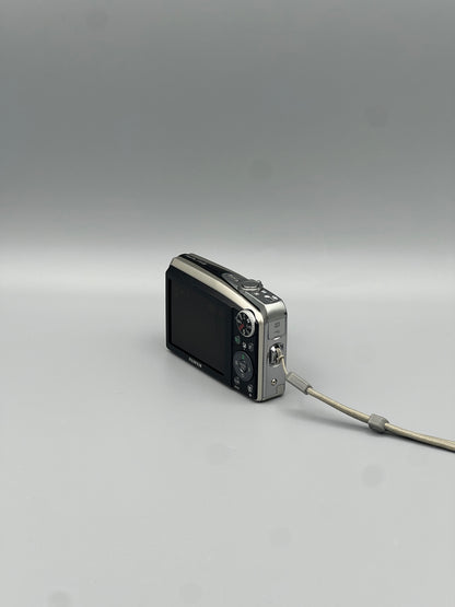 Fujifilm FinePix F50FD viewed from a rear angle showing the LCD screen, controls and side panel.
