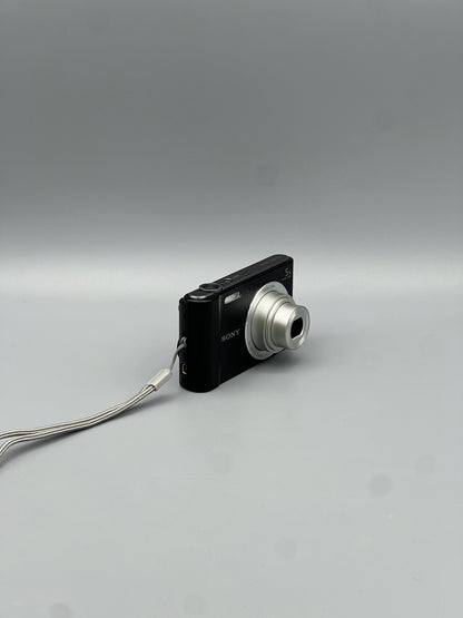 Black Sony Cyber-shot DSC-W800 viewed from a front angle with its silver lens extended.