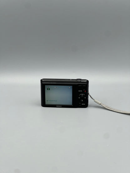 Sony Cyber-shot DSC-W800 rear view showing the LCD screen, control buttons and wrist strap.