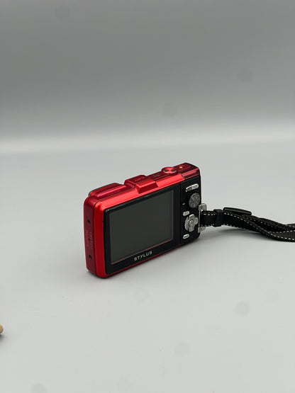 Angled rear view of a red Olympus Stylus Tough TG-830 showing the LCD screen and black control panel