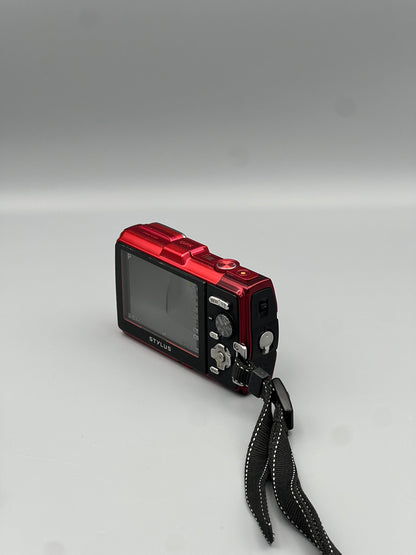 Rear and side view of a red Olympus Stylus Tough TG-830 with a black wrist strap