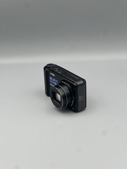 Front and side view of a black Sony Cyber-shot DSC-H70 with its lens extended