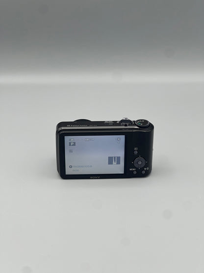 Rear view of a black Sony Cyber-shot DSC-H70 showing the illuminated LCD screen and control buttons