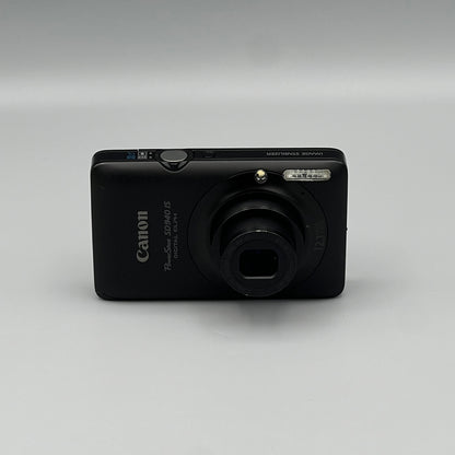 Black Canon PowerShot SD940 IS front view with its lens extended.