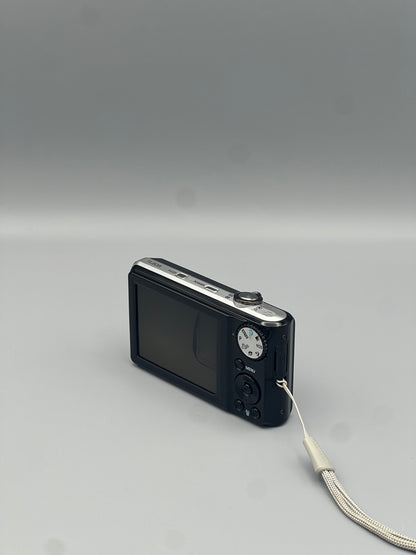 Angled rear view of a black Samsung TL205 showing the LCD screen and control panel