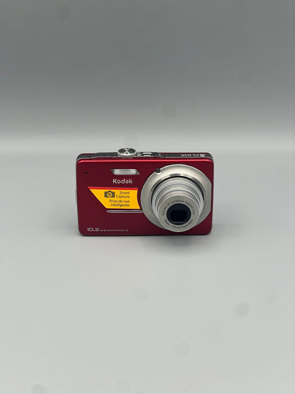 Red Kodak EasyShare M340 front view with its silver lens extended.